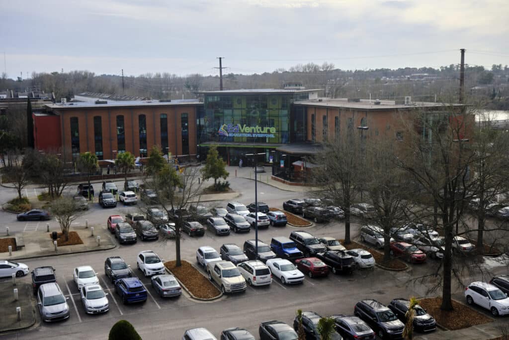Photo of a parking lot with a building that says EdVenture in the background.