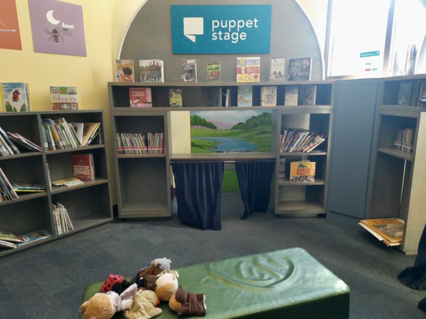 A puppet stage and bookshelves at the Columbia EdVenture Childrens Museum.