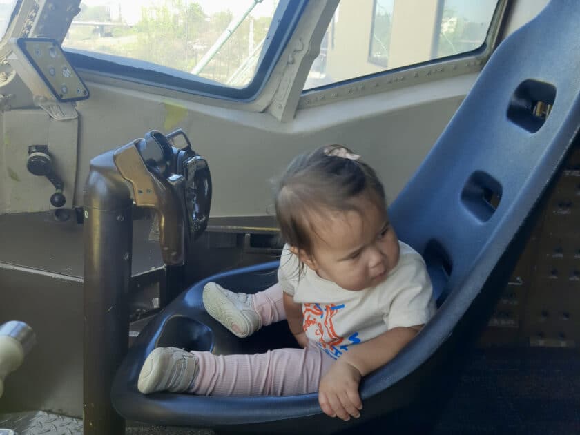 Child in a pilot seat of a plane at EdVenture Museum in Columbia, SC.