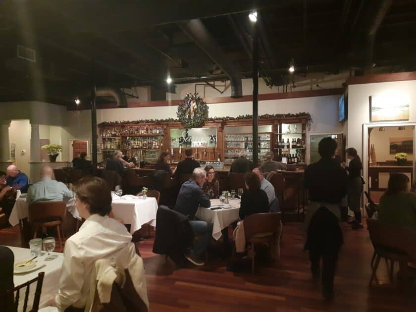 Interior view of Saluda's Restaurant in Columbia, SC with people eating at tables.