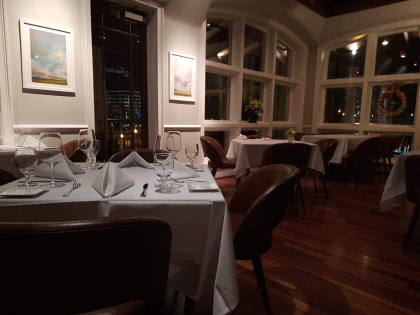An empty set table with a door to a balcony and other tables in the background at Saluda's in Five Points in Columbia, SC.