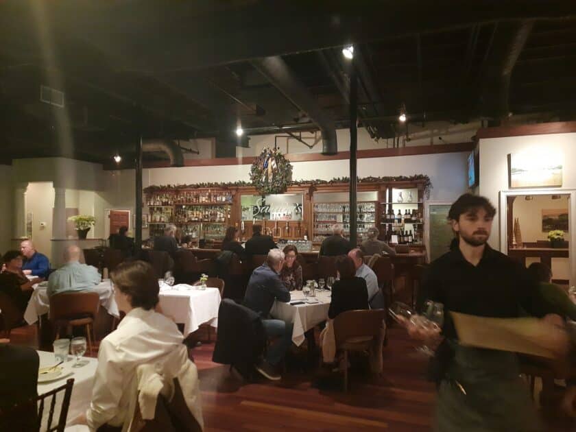 Tables with diners and waiters walking around at Saluda's Restaurant in Columbia, South Carolina.