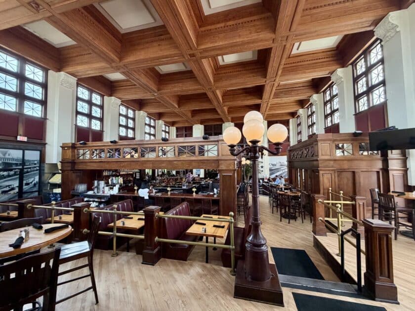 The bar, tables, booths, railings, and lamps in the interior of the California Dreaming Restaurant in Columbia.