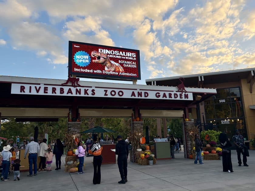 Main entrance to Riverbanks Zoo with a sign for Dinosaurs Around the World above it.